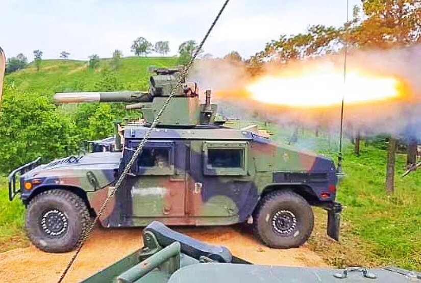 A missile launches from atop a Humvee, shooting flames behind it.