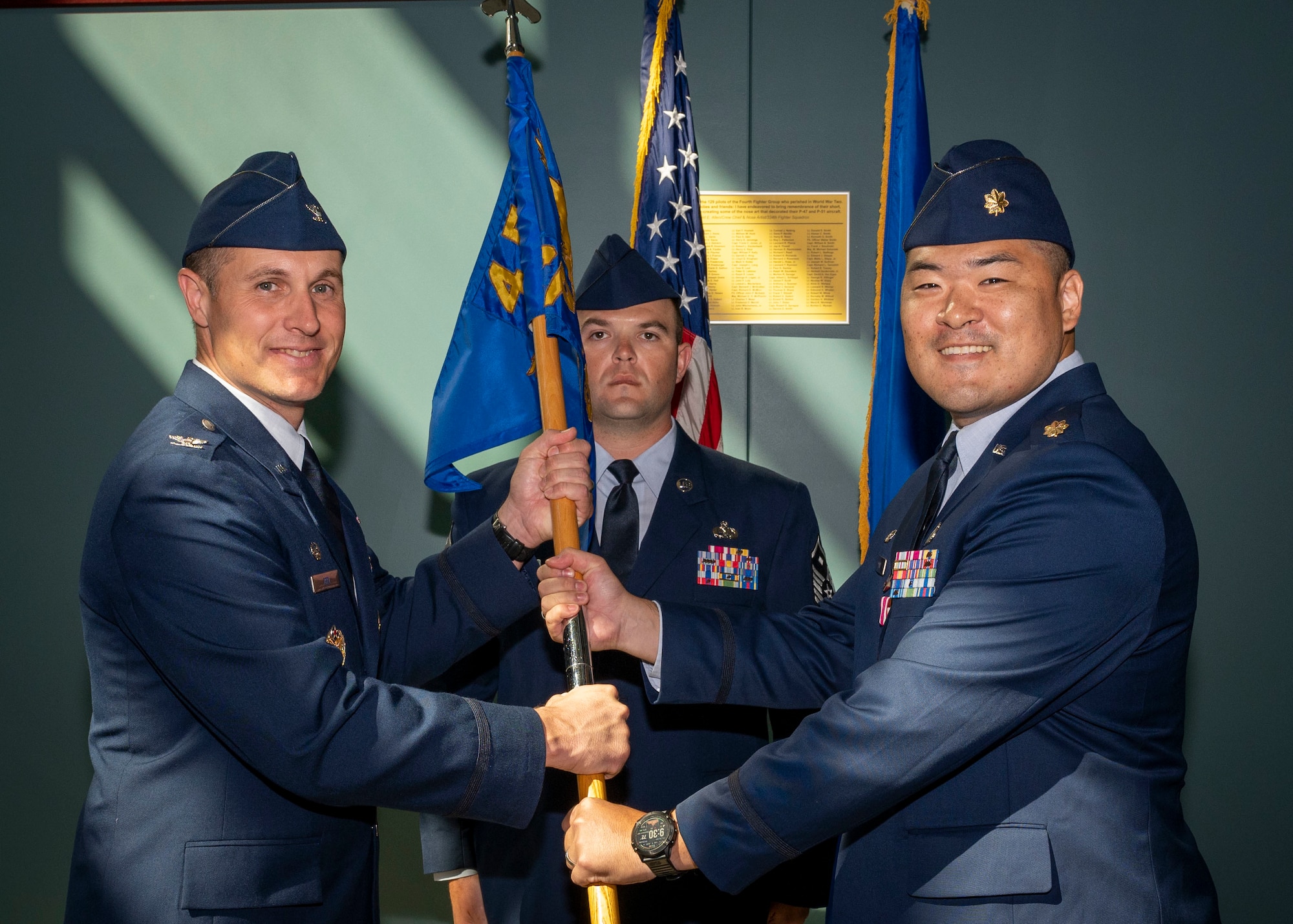 Maj. Samuel Han, right, outgoing 4th Comptroller Squadron commander, relinquishes the guidon to Col. Lucas Teel, 4th Fighter Wing commander, during the 4th CPTS change of command ceremony at Seymour Johnson Air Force Base, North Carolina, June 24, 2022.