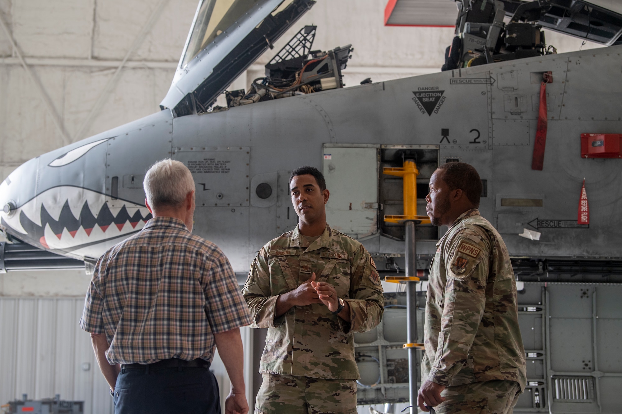 U.S. Air Force Master Sgt. Kareem Samuel, 23rd Maintenance Group chief of innovation, middle, speaks with Gary Adams, Goldratt consultant, left, and Tech. Sgt. Delrico Harris 74th Fighter Generation Squadron weapons expeditor at Moody Air Force Base, Georgia, June 15, 2022.