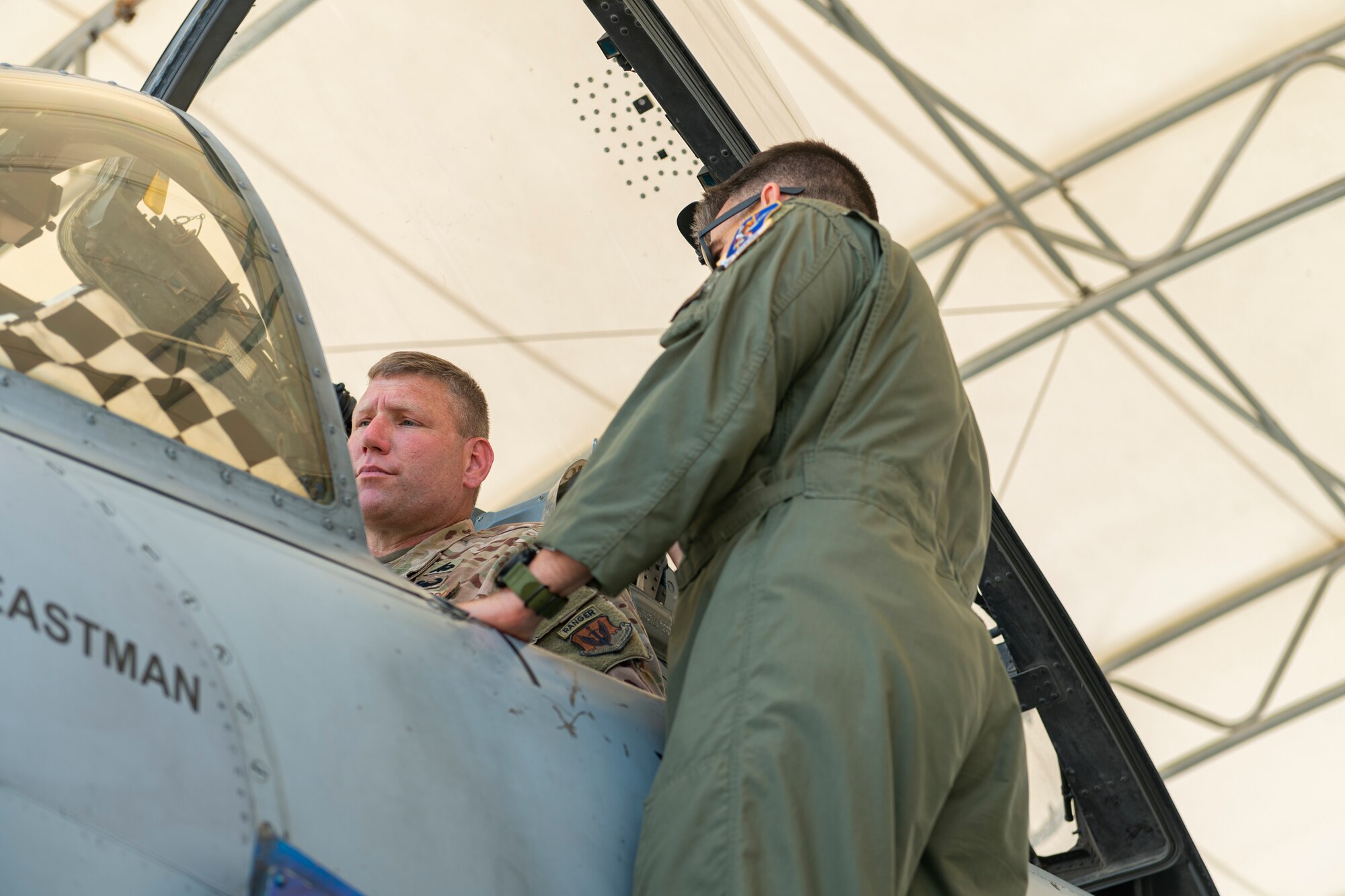 Photo of an Airman inspecting the cockpit of an A-10C Thunderbolt II