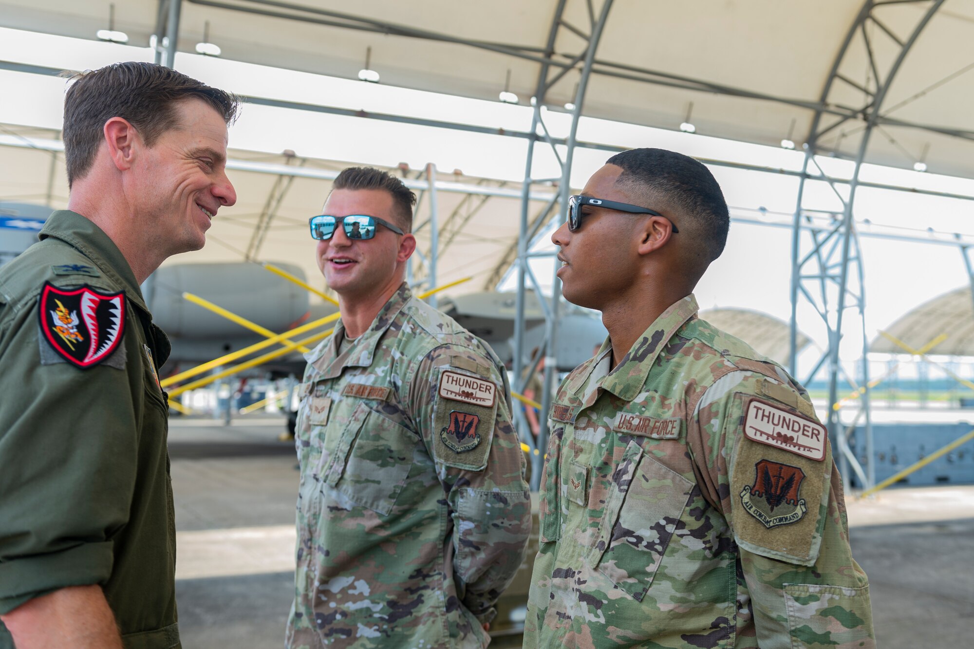 Photo of an Airman talking to crew chiefs