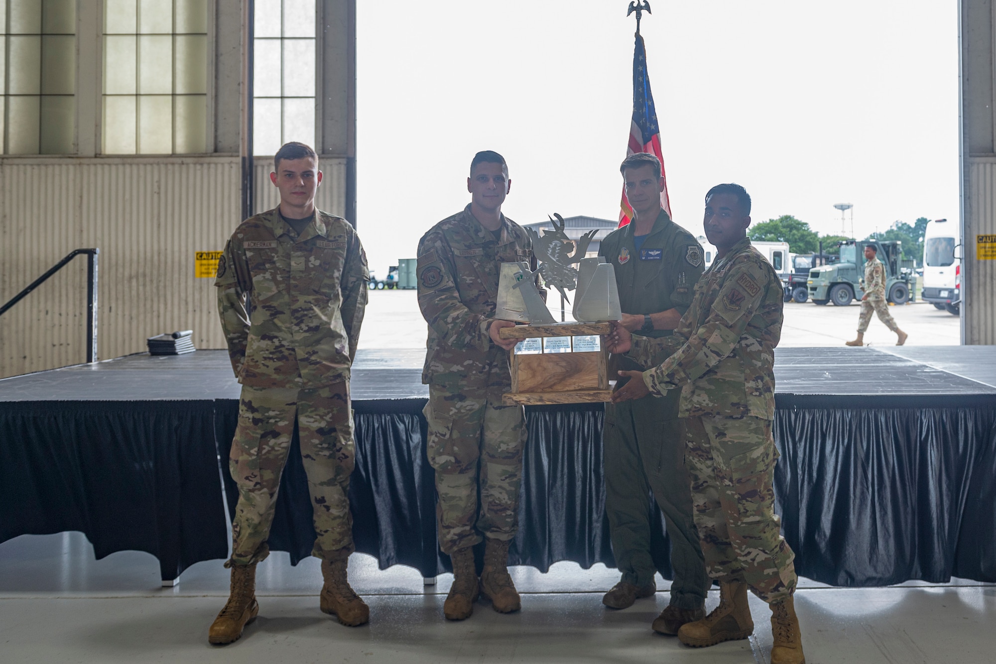 Photo of an Airman presenting a trophy