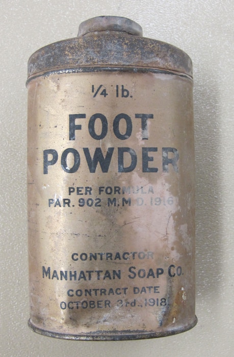 Silver cylinder with foot powder label