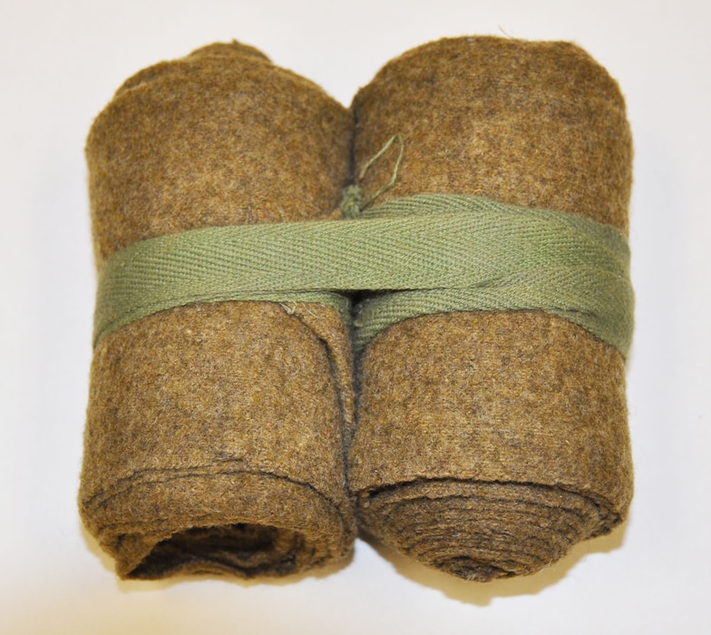 Two bundled rolls of wool cloth
