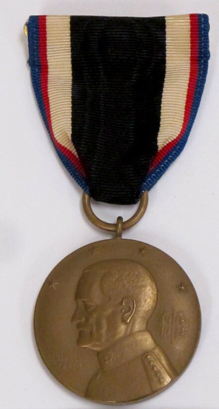 Round gold medal on a ribbon