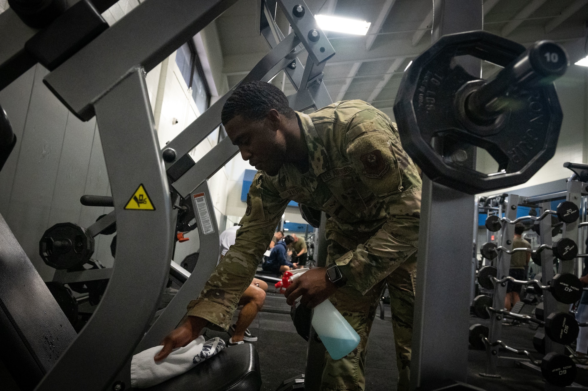 U.S. Air Force Senior Airman Richard Vaughn, a 1st Special Operations Force Support Squadron fitness center apprentice, cleans equipment at Hurlburt Field, Florida, June 16, 2022.