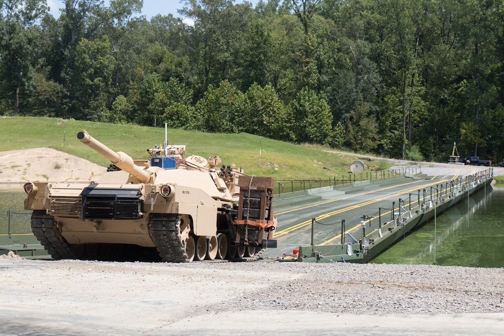 A modified M1 Abrams tank lines up to cross an Improved Ribbon Bridge (IRB) erected in a testing basin at the U.S. Army Engineer Research and Development Center (ERDC), Sept. 1, 2021. Researchers from the ERDC are testing the high military load capacity vehicle weight limits of the IRB to determine under what operational conditions they can safely cross.