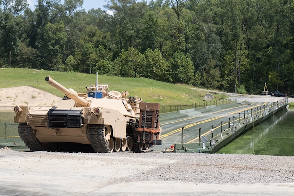 A modified M1 Abrams tank lines up to cross an Improved Ribbon Bridge (IRB) erected in a testing basin at the U.S. Army Engineer Research and Development Center (ERDC), Sept. 1, 2021. Researchers from the ERDC are testing the high military load capacity vehicle weight limits of the IRB to determine under what operational conditions they can safely cross.