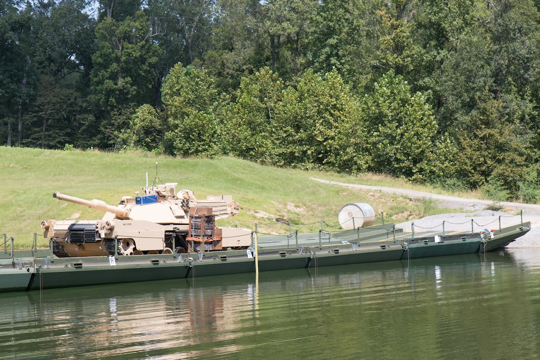 A modified M1 Abrams tank crosses an Improved Ribbon Bridge (IRB) erected in a testing basin at the U.S. Army Engineer Research and Development Center (ERDC), Sept. 1, 2021. Researchers from the ERDC are testing the high military load capacity vehicle weight limits of the IRB to determine under what operational conditions they can safely cross.