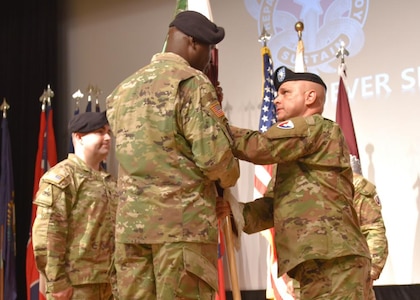 U.S. Army Medical Materiel Center-Korea outgoing commander Lt. Col. Marcus Perkins, right, passes the organizational colors to Army Medical Logistics Commander Col. Tony Nesbitt, center, as he relinquishes command on June 24, 2022. Lt. Col. Mark Sander, left, assumes command of the unit charged with providing continuous medical logistics support to sustain the readiness of U.S. Forces Korea throughout the full range of military operations.