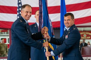 Col. Jason Holcomb, right, assumes command of the 436th Mission Support Group after receiving the guidon from Col. Matt Husemann, left, 436th Airlift Wing commander, during a change of command ceremony held at the base fire station on Dover Air Force Base, Delaware, June 27, 2022. Holcomb began his military career at Dover AFB and has returned after more than 20 years. (U.S. Air Force photo by Senior Airman Faith Schaefer)
