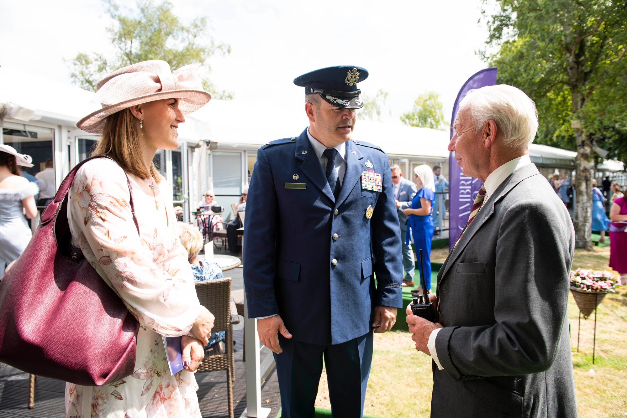 U.S. Air Force Col. Brian Filler, center, 501st Combat Support Wing commander, engages with attendees during the Cambridgeshire County Day at the Newmarket July Course, England, June 23, 2022. The County Day was an opportunity to celebrate Cambridgeshire and Her Majesty The Queen’s Platinum Jubilee. (U.S. Air Force photo by Senior Airman Jennifer Zima)