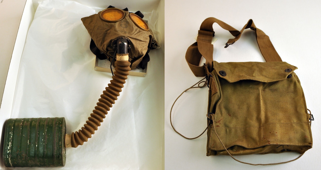 Mask with eyeholes and hose next to bag with strap