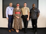 IMAGE: (From left) Naval Surface Warfare Center Dahlgren Division Dam Neck Activity (NSWCDD DNA) Chief of Staff Eric LaCross; Founder of Mx. Kelley Queer Education, LLC. Mx. Jacob Kelley; Yeoman 2nd Class Joshua Kelley and DNA Equal Employment Opportunity Specialist Marcus Matthews gather for a photo following the NSWCDD DNA Lesbian, Gay, Bisexual, Transgender, Queer+ (LGBTQ+) Pride Month event on June 8, where Mx. Kelley was the guest speaker. The purpose of the event, which was hosted by the NSWCDD DNA Diversity and Inclusion Program, was to educate the workforce and help break down barriers that may impede equal opportunities for members of the LGBTQ+ community.