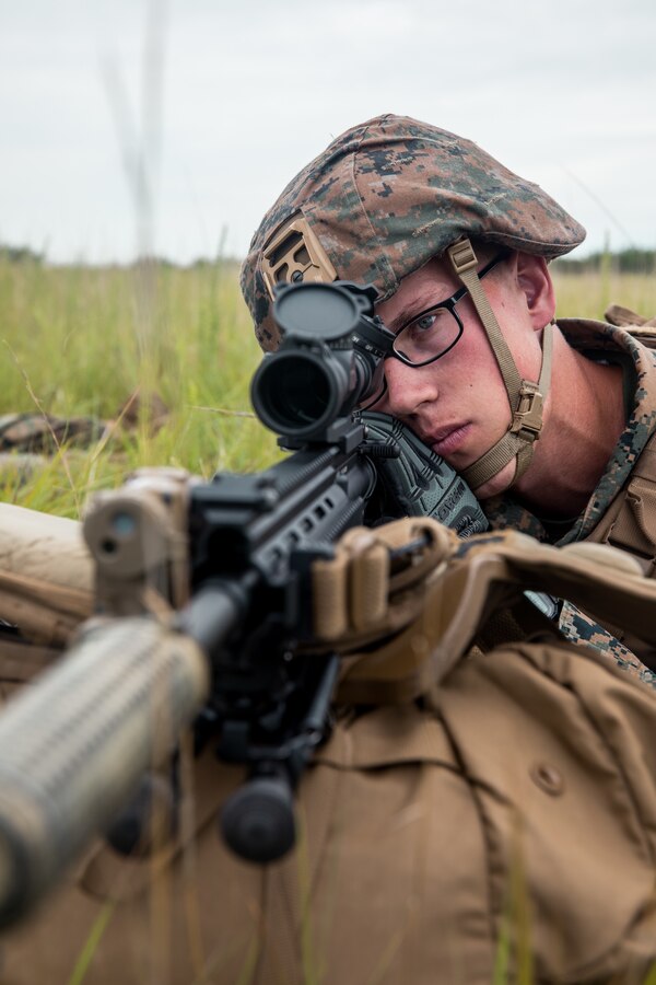U.S. Marine Corps Lance Cpl. Logan Otto, a designated marksman with Foxtrot Co., 2nd Battalion, 24th Marine Regiment, 4th Marine Division, Marine Forces Reserve, from Lake Mills, Wisconsin, establishes security in a field at Gunslinger 22 in Riley, Kansas, June 22, 2022. Exercise Gunslinger 22 is a joint exercise with the Kansas Air National Guard and U.S. Marine Corps designed to increase aircraft control and training for potential real-world contingencies. (U.S. Marine Corps photo by Lance Cpl. David Intriago)