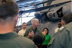 Vice Adm. Karl Thomas, Commander, U.S. 7th Fleet, center, speaks with Sailors assigned to Helicopter Sea Combat Squadron (HSC) 23 in the hangar bay aboard amphibious assault carrier USS Tripoli (LHA 7), June 16, 2022. Tripoli is operating in the U.S. 7th Fleet area of operations to enhance interoperability with allies and partners and serve as a ready response force to defend peace and maintain stability in the Indo-Pacific region.
