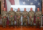 From left, Chief Warrant Officer 5 Brian Erkson of Connecticut; Chief Warrant Officer Frank Albanese of New Jersey; Chief Warrant Officer 5 Scott Beaulieu of Vermont; Chief Warrant Officer 5 Chris Merrill of Maine; Chief Warrant Officer 5 Jay Vincent of Massachusetts; and Chief Warrant Officer 5 George Munson of New Hampshire pose at the state military reservation's Heritage Room in Concord New Hampshire on June 23, 2022.