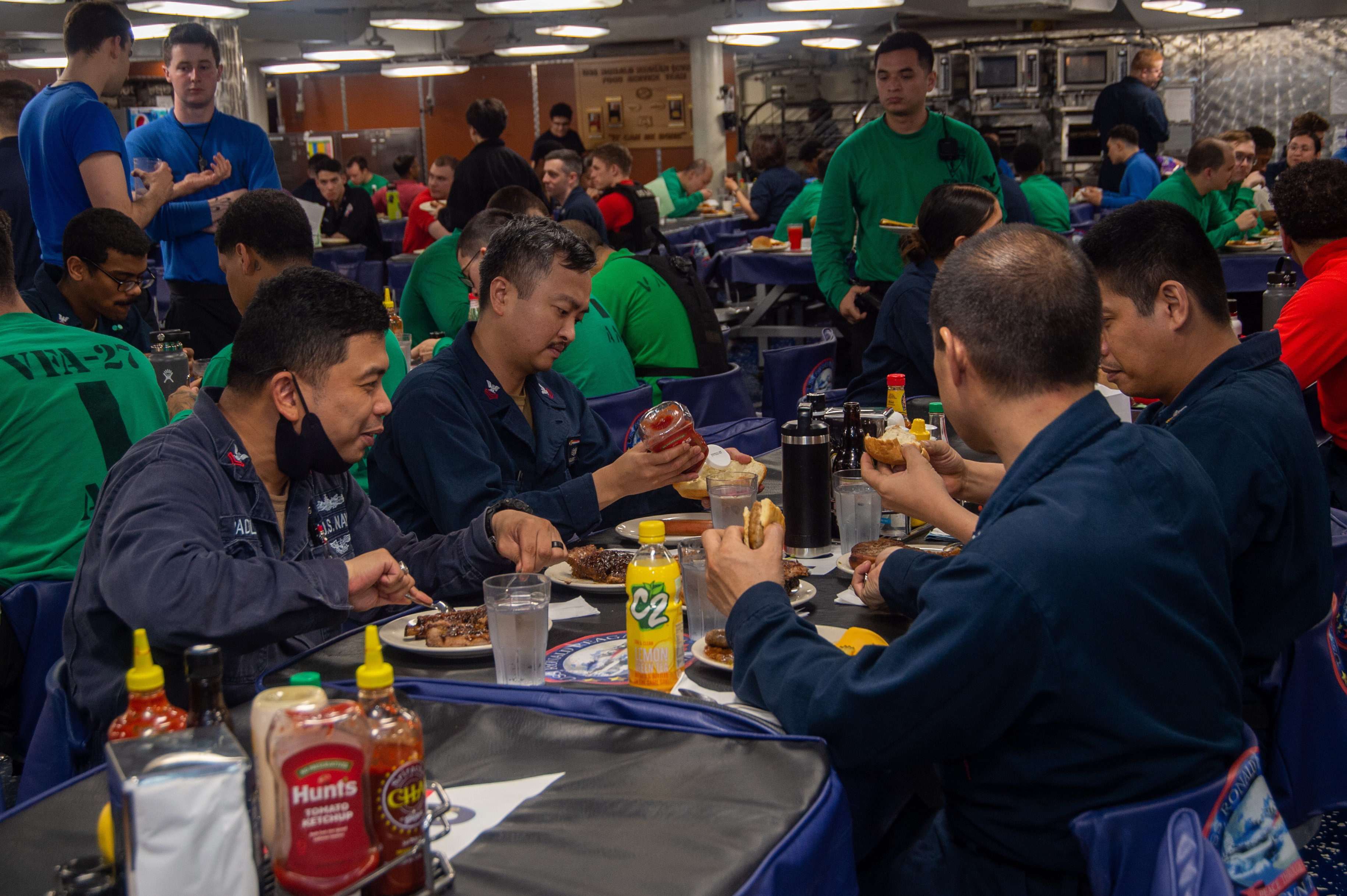 Sailors eat a Juneteenth celebration meal on the aft mess deck of the U.S. Navy’s only forward-deployed aircraft carrier USS Ronald Reagan (CVN 76), June 20, 2022.