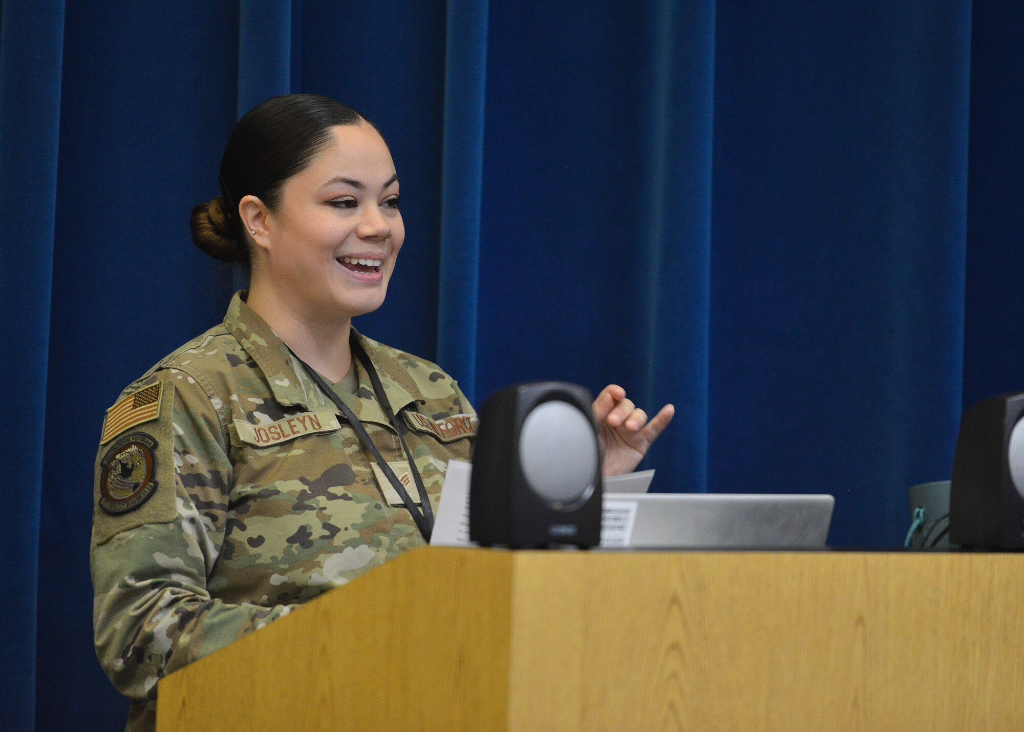 A woman speaks at a podium.