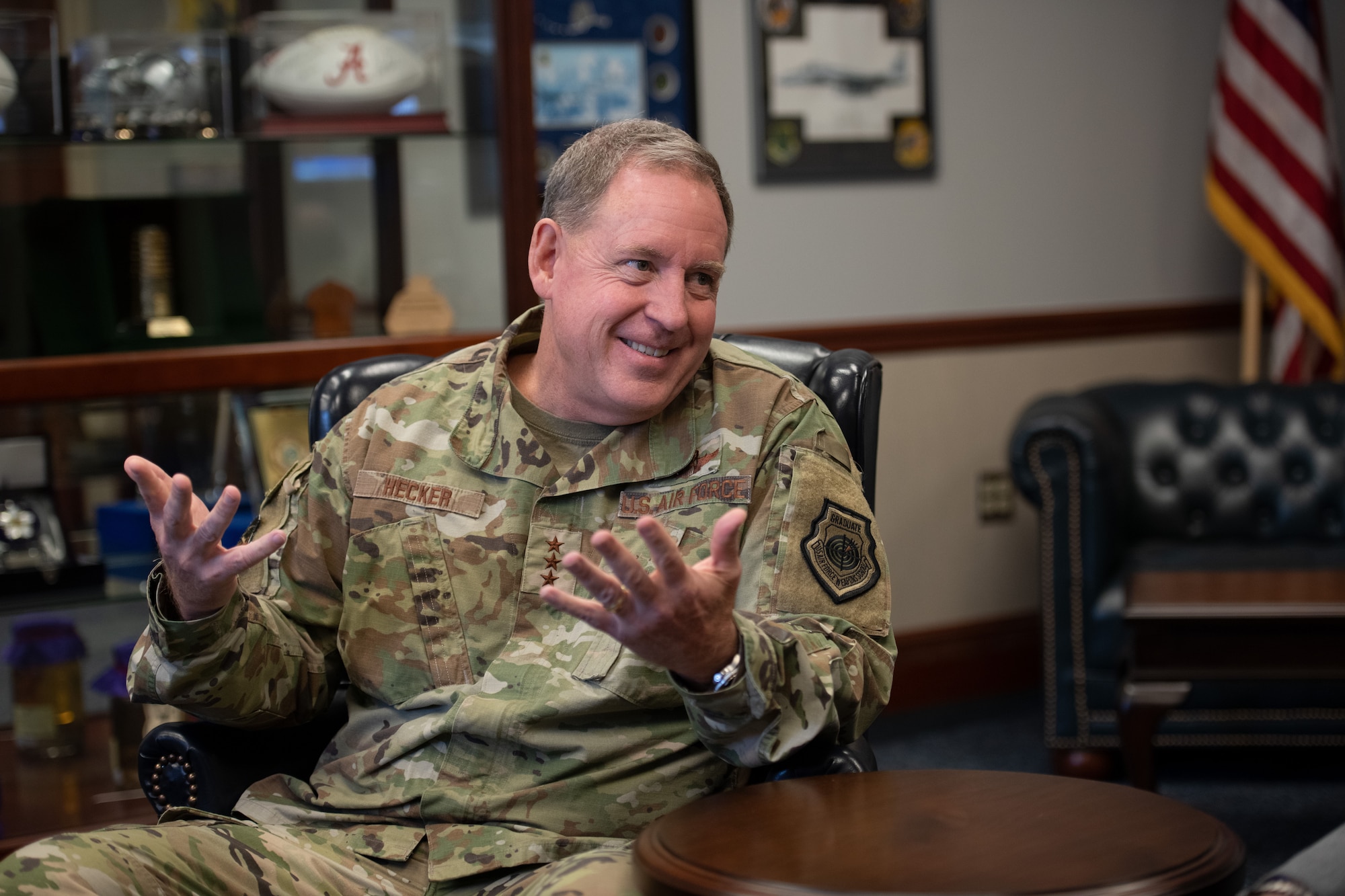 Then-Lt. Gen. James Hecker sat with a smile on his face and hands out as he answers interview questions about his nearly three years as commander and president of Air University at Maxwell Air Force, Alabama. (U.S. Air Force photo by Airman 1st Class Greydon Furstenau)