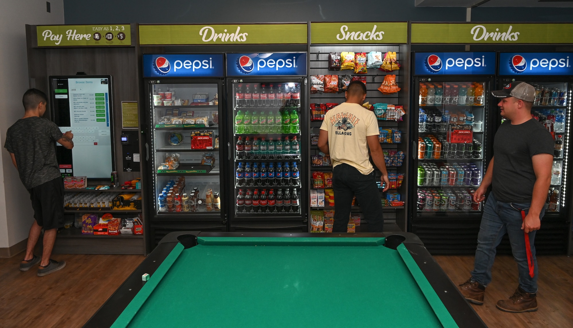 Atlantis dorm Airmen look throuh the mini-market selection at the Atlantis dorm on Whiteman Air Force Base, Missouri, June 22, 2022. The mini-market is meant to bring the base shoppette to dorm Airmen who have swing shifts or are just needing a late night snack.