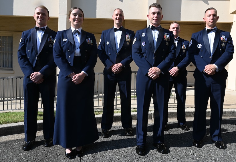 The 2022 Praetorian Order inductees stand for a group photo prior to the induction ceremony on Joint Base Anacostia-Bolling, Washington, D.C., June 24, 2022. From left to right, Staff Sgt. Robert Day, Senior Airman Brooke Sanchez, Tech. Sgt. Casey Randolph, Staff Sgt. Jeffery Herron, Tech. Sgt. Charles Schlichtmann, and Tech. Sgt. Brandon Jones. Praetorians are recognized for their long-lasting contributions to the legacy of the United States Air Force Honor Guard. (U.S. Air Force photo by 2nd Lt. Brandon DeBlanc)
