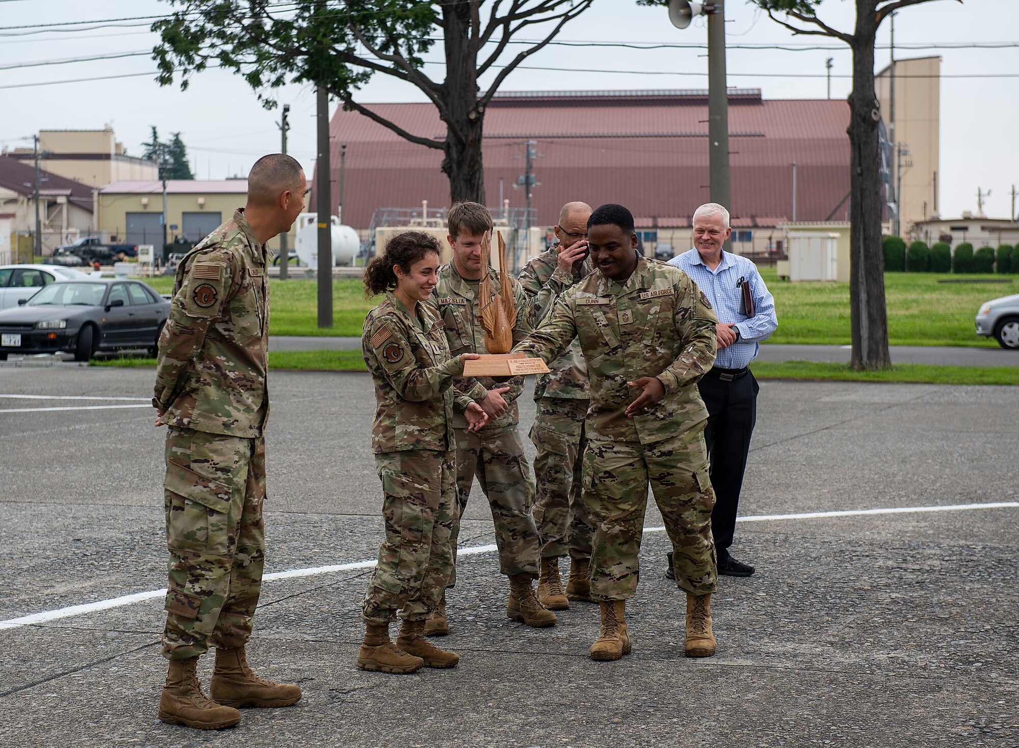 374th Airlift Wing command chief presents the 2022 American Petroleum Institute Award to the 374th Logistics Readiness Squadron Fuels Management Flight