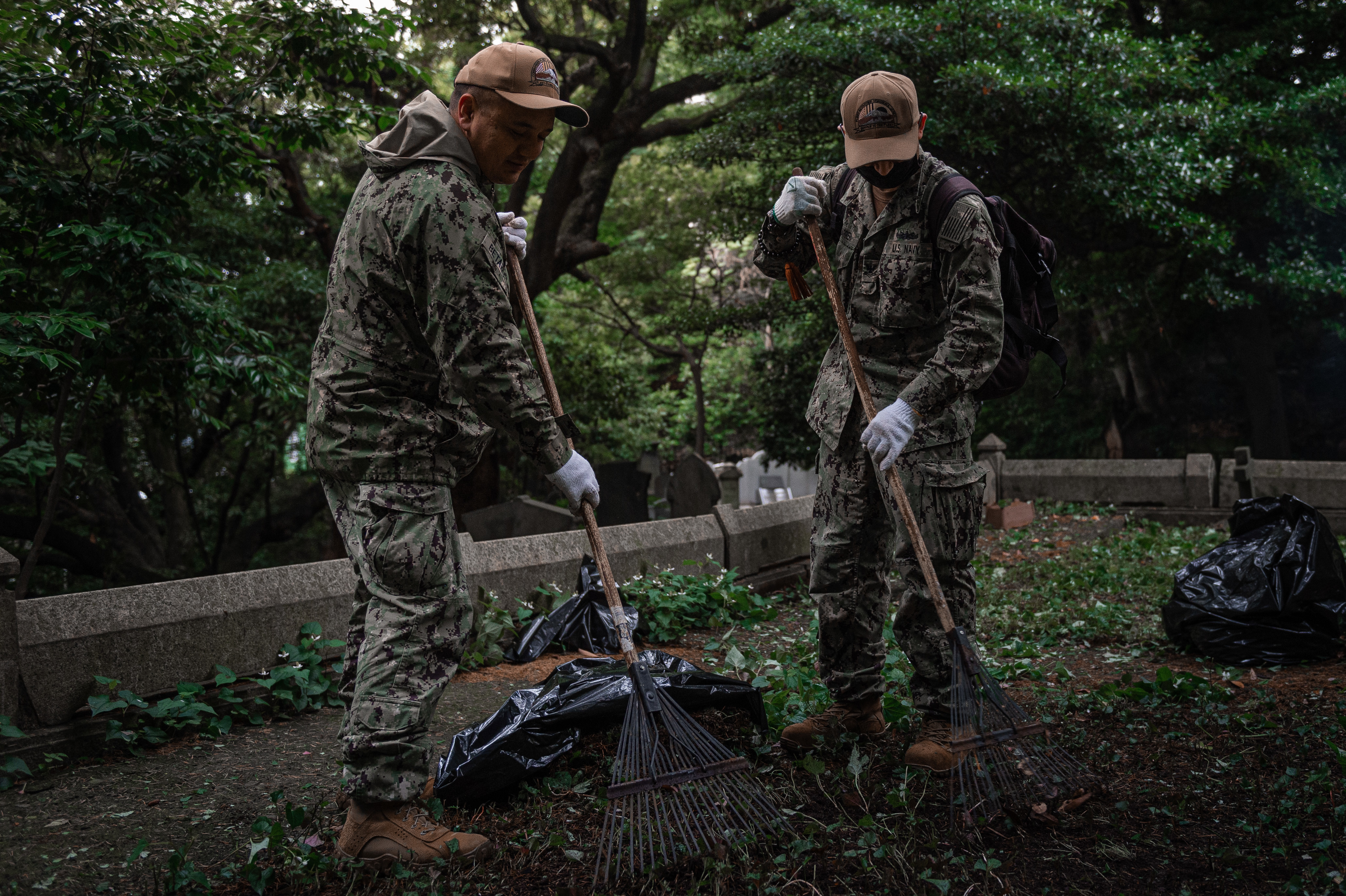 Master-at-Arms First Class Edison Bentacur and Retail Services Specialist Second Class Ernest Barrera volunteers during a cleanup event at the Yokohama Foreign General Cemetery.