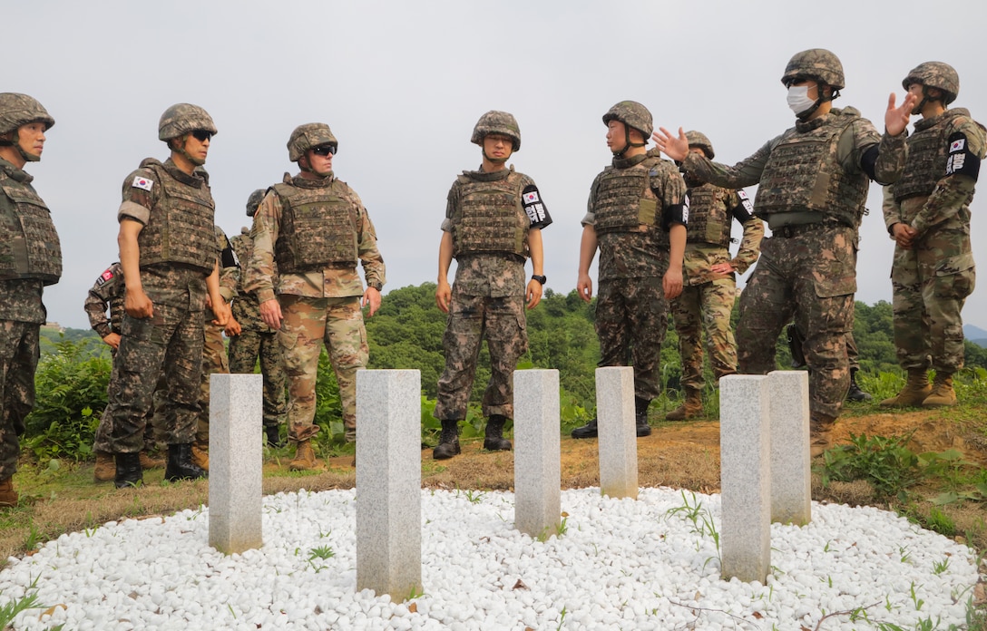 Command senior enlisted leaders with the ROK-US Alliance gather around a site where human remains where discovered after the Korean War at South Korea, June 22, 2022.