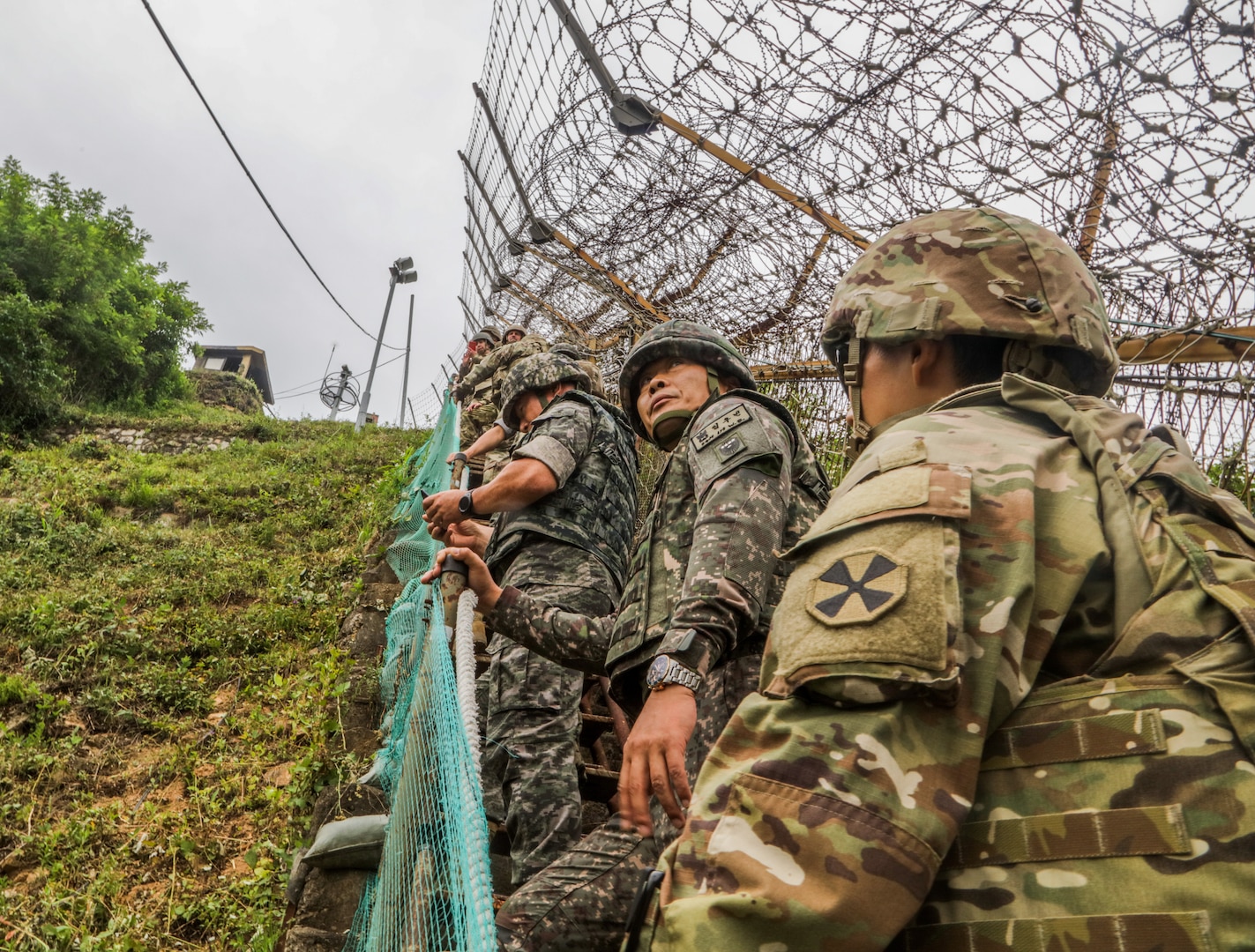 Command senior enlisted leaders with the ROK-US Alliance climb stairs up a mountain to arrive at the Republic of Korea's 3rd Infantry Division Guard Observation Post, June 23, 2022.