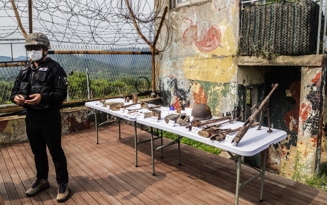 A Republic of Korea Soldier demonstrates recovered items from the Korean War at Arrow Head Ridge 281, South Korea, June 22, 2022.