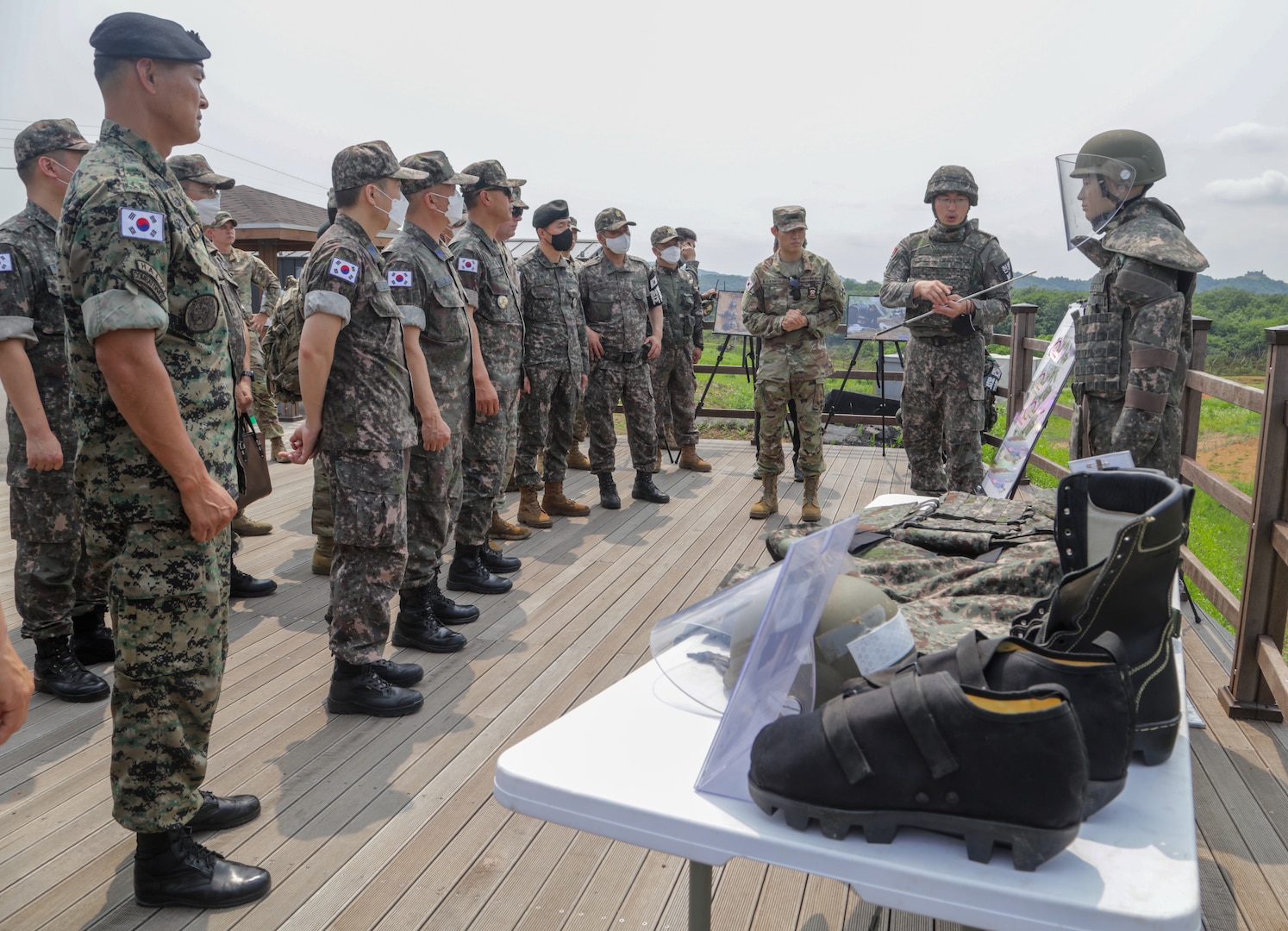 A Republic of Korea Army Major briefs a group of ROK-US Alliance command senior enlisted leaders on the explosive ordnance disposal equipment that remains recovery specialists use at Arrow Head Ridge 281, South Korea, June 22, 2022.