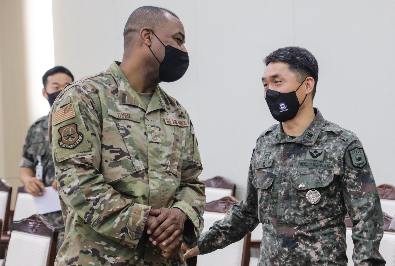 Command Chief Master Sgt. Alvin R. Dyer, senior enlisted advisor for 7th Air Force, and Command Sgt. Major Yong-kyu Lee, senior enlisted advisor for the Combined Forces Command Republic of Korea forces, share a moment of camaraderie at the ROK Chiefs of Staff Headquarters, June 21, 2022.