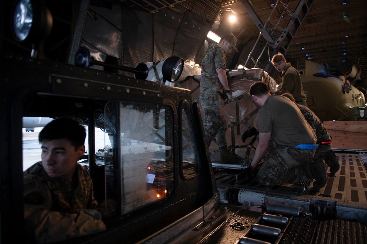 436th Aerial Port Squadron ramp services personnel load cargo onto a C-5M Super Galaxy during a foreign military sales mission at Dover Air Force Base, Delaware, June 16, 2022. The U.S. and Australia maintain a robust relationship that serves as an anchor for peace and stability in the Indo-Pacific region and around the world. Due to its strategic location, Dover AFB supports approximately $3.5 billion worth of foreign military sales annually. (U.S. Air Force photo by Tech. Sgt. J.D. Strong II)
