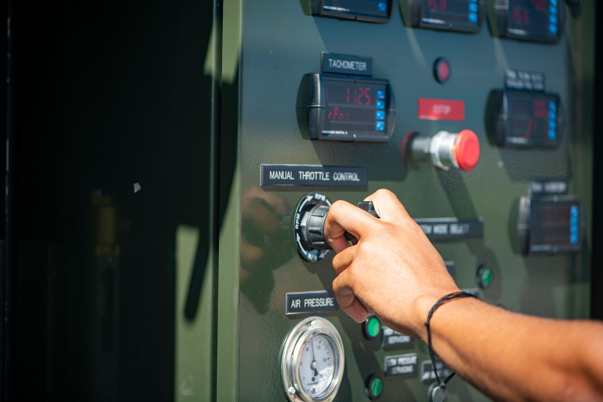 An Airman's hand is seen turning a knob to hot pit refuel a F-15C Eagle with the Versatile Integrating Partner Equipment Refueling (VIPER) kit