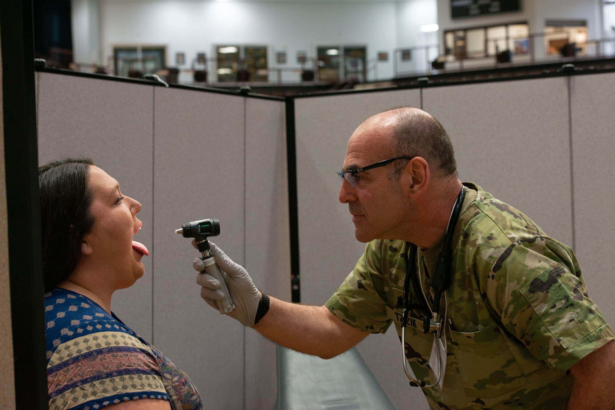 Lt. Col. Dan Tzizik, the medical officer in charge from the New Hampshire Army National Guard Medical Detachment, screens Tara Parker Dorler, a daycare provider, during the Cherokee Nation Innovative Readiness Exercise June 5, 2022. Parker Dorler was the first patient at the clinic set up inside the Sequoyah High School in Tahlequah, Oklahoma.