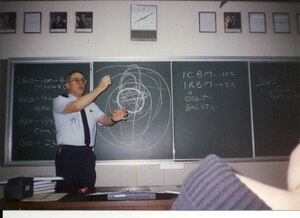 Retired Senior Master Sgt. David Weissgerber, aerospace science instructor, Air Force Junior ROTC Unit JA-932, Kadena High School, Okinawa, Japan, teaches the basics of orbital mechanics to cadets in the mid-1980s. Upon retiring after a distinguished 23 year active duty career, Weissgerber embarked on a 35-year career as an AFJROTC instructor, making him the longest tenured instructor in the history of the AFJROTC enterprise.
