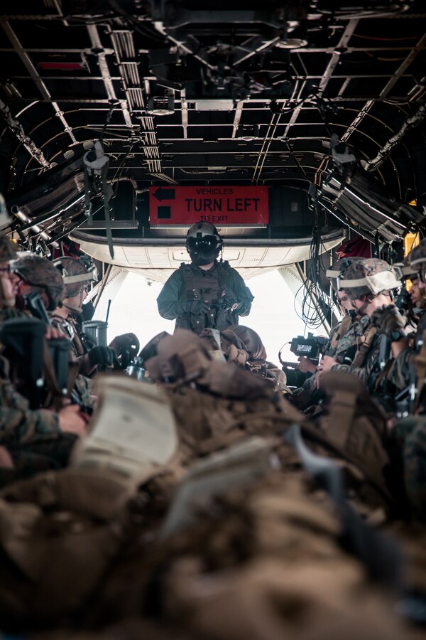 A crew chief with Marine Heavy Helicopter Squadron (HMH) 772, 4th Marine Aircraft Wing, Marine Forces Reserve, oversees the cabin of a CH-53E Super Stallion over a field at exercise Gunslinger 22 in Riley, Kansas, June 22, 2022. Exercise Gunslinger 22 is a joint exercise with the Kansas Air National Guard and U.S. Marine Corps designed to increase aircraft control and training for potential real-world contingencies. (U.S. Marine Corps photo by Lance Cpl. David Intriago)