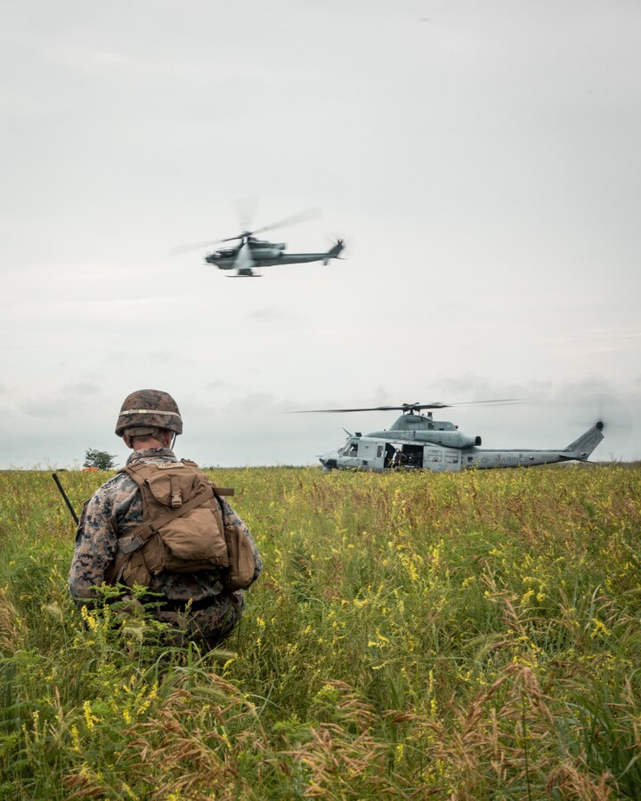 A U.S. Marines with Foxtrot Co., 2nd Battalion, 24th Marine Regiment, 4th Marine Division, Marine Forces Reserve, establish security next to a UH-1Y Venom at exercise Gunslinger 22 in Riley, Kansas, June 22, 2022. Exercise Gunslinger 22 is a joint exercise with the Kansas Air National Guard and U.S. Marine Corps designed to increase aircraft control and training for potential real-world contingencies. (U.S. Marine Corps photo by Lance Cpl. David Intriago)