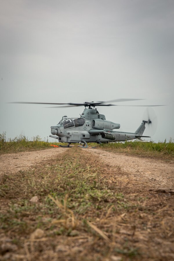 A U.S. Marine Corps AH-1Z Viper from Marine Light Attack Helicopter Squadron (HMLA) 773 Detachment A, 4th Marine Aircraft Wing, awaits refueling within a Forward Arming and Refueling Point (FARP) at Gunslinger 22 in Salina, Kansas, June 22, 2022. The purpose of a FARP is to refuel on coming aircraft or ground vehicles in order for them to carry on the plan of attack. (U.S. Marine Corps photo by Lance Cpl. David Intriago)
