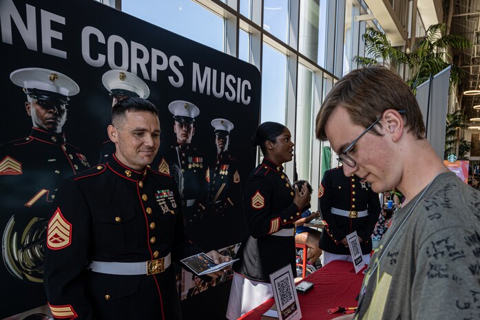 U.S. Marine Staff Sgt. Byron Reed, 9th Marine Corps District musician technical assistant speaks with students during the Music for All Summer Symposium 2022 at Ball State University in Muncie, Ind., June 25, 2022.  National Partnerships help to engage key influencers and increase awareness of the Marine Corps’ opportunities.  Each partnership is developed with the intention of connecting Marines with organizations in order to build relationships and understanding of the Marine Corps. (U.S. Marine Corps photo by Lance Cpl. Gustavo Romero).