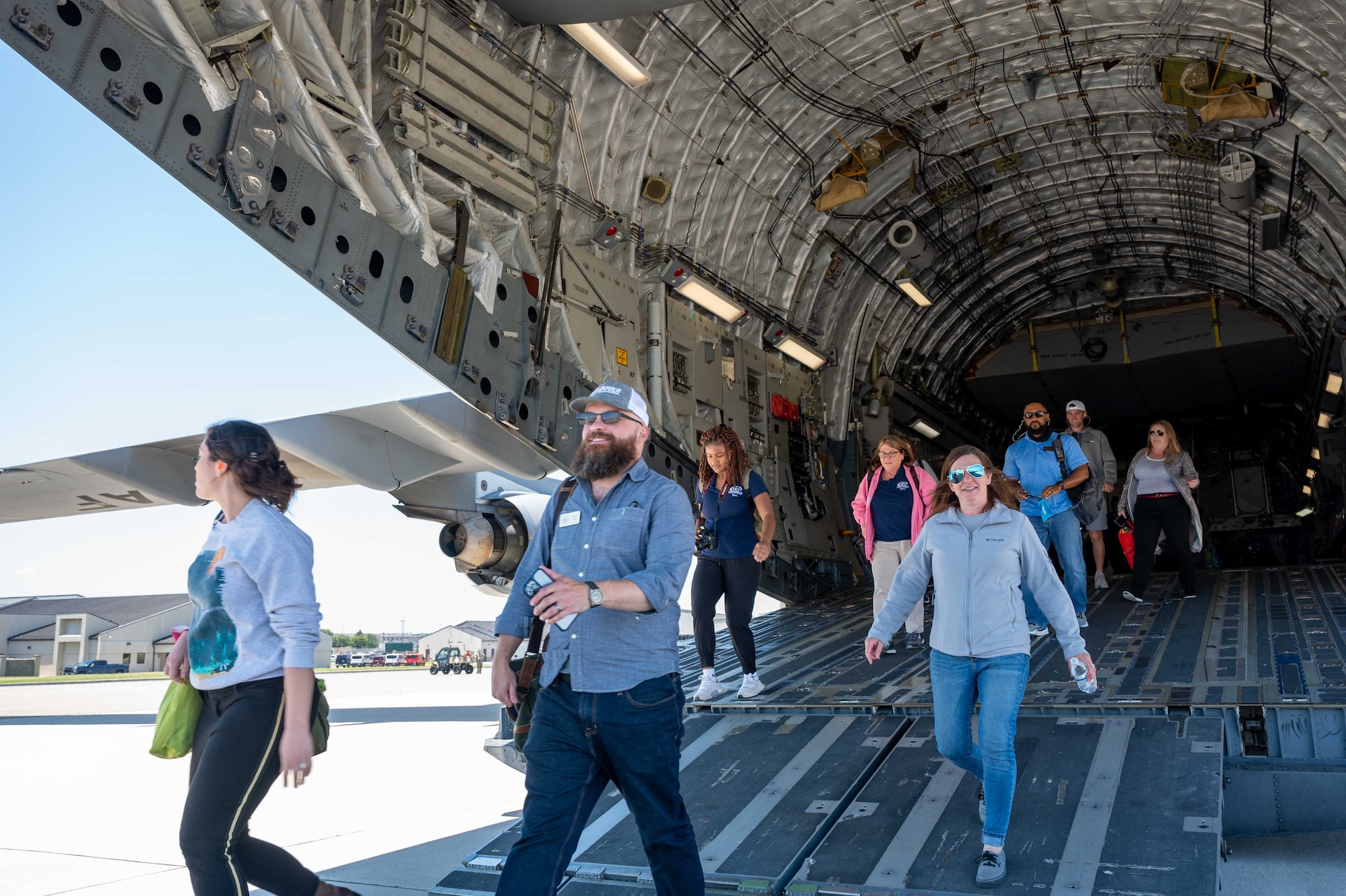 Leadership Central Delaware members walk down a C-17 Globemaster III ramp after an incentive flight at Dover Air Force Base, Delaware, June 15, 2022. The LCD community leaders were given the opportunity for the incentive flight to gain awareness and advocacy for Team Dover. (U.S. Air Force photo by Senior Airman Faith Schaefer)