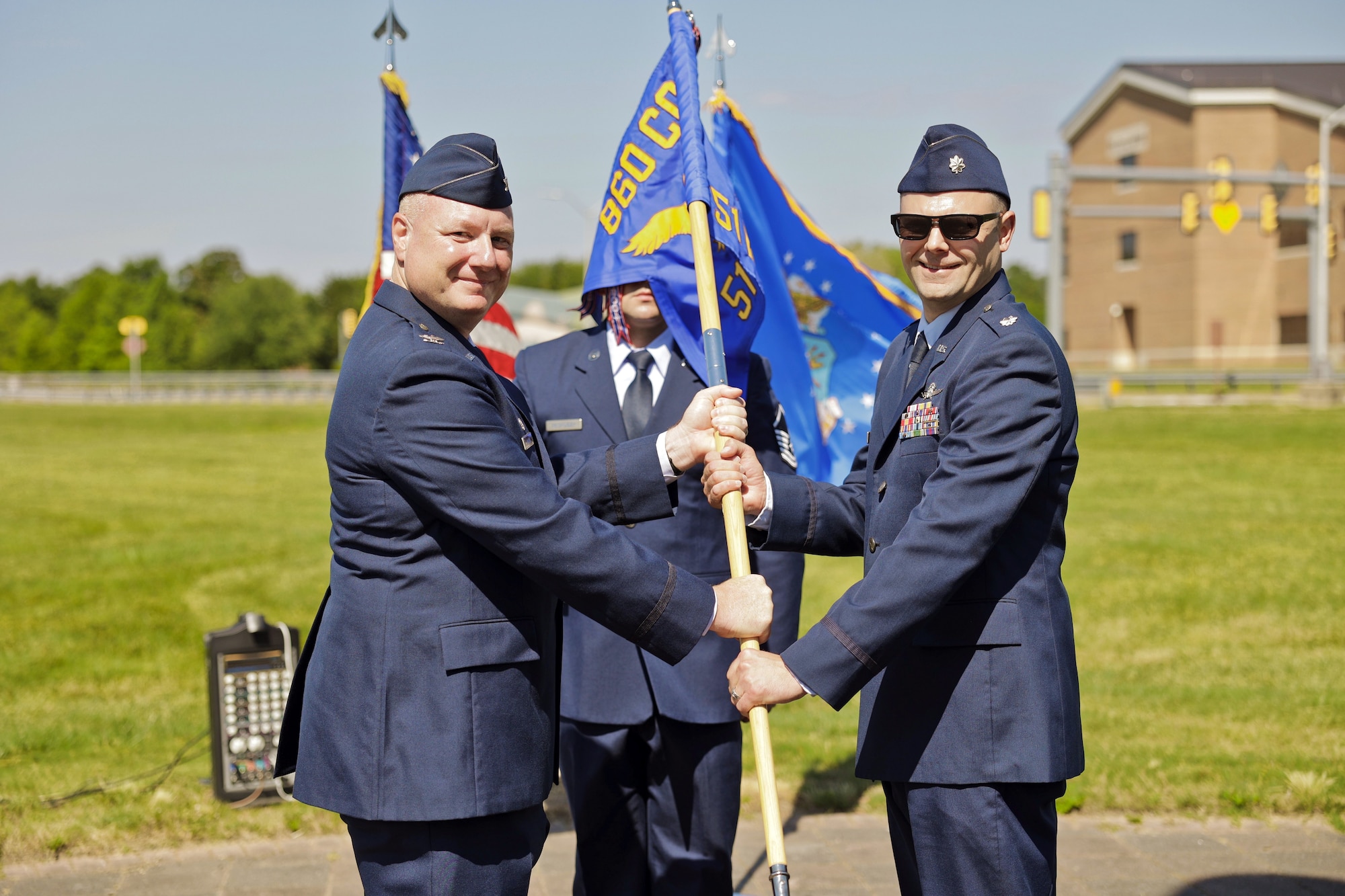 Col. Thaddeus Janicki Jr., 860th Cyberspace Operations Group commander, passes the 51st Network Operations Squadron guidon to Lt. Col. Ernest Moore, signifying his assumption of command of the squadron June 11, 2022, at Joint Base Langley-Eustis, Virginia. The 51st NOS is a geographically separated unit of the 860th COG, located at Robins Air Force Base, Georgia. (Courtesy photo)