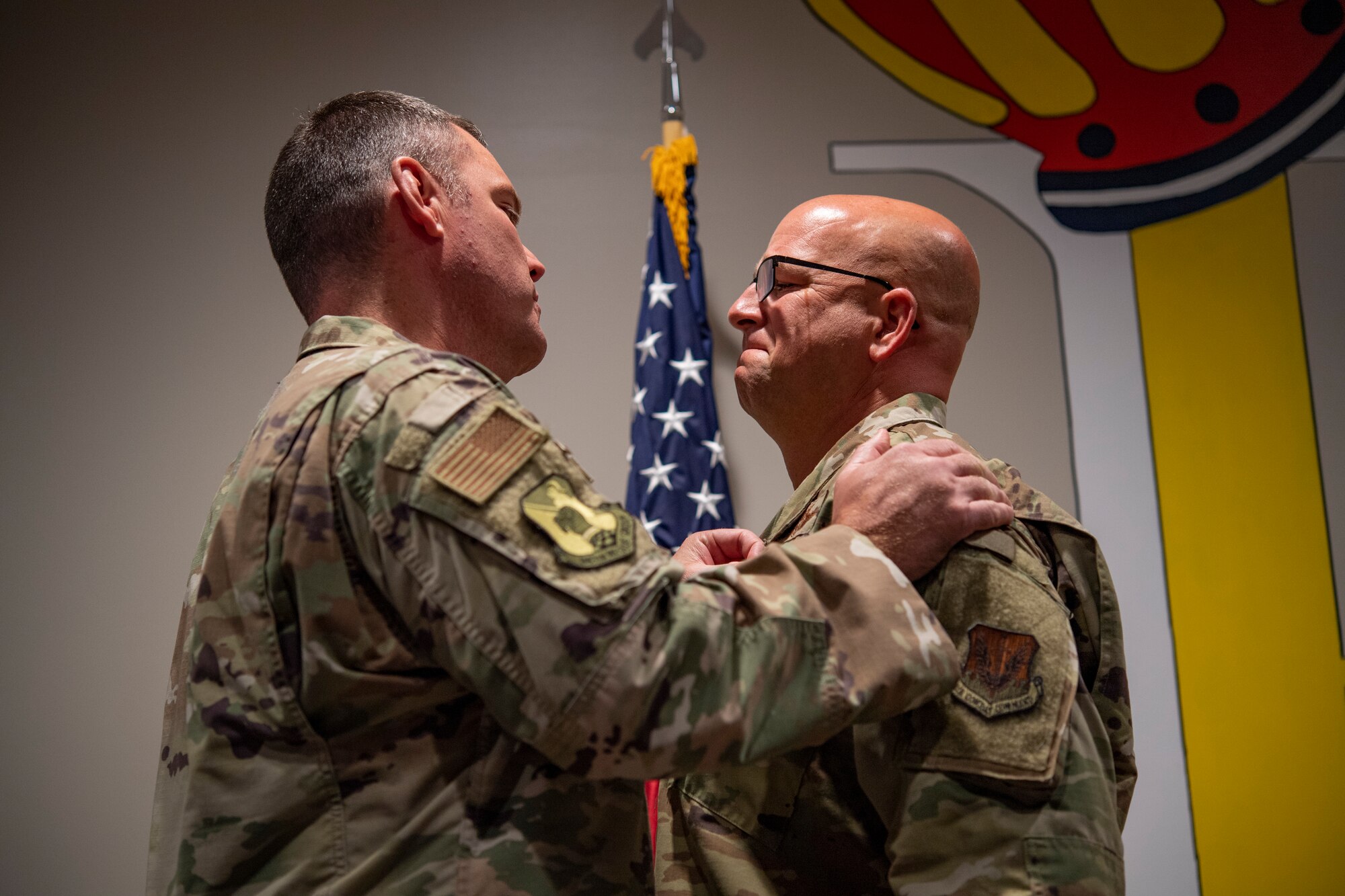 U.S. Air Force Col. Chris Richardson, 347th Rescue Group commander, congratulates Senior Master Sgt. Brandon Bitler, 71st Rescue Squadron, during an awards ceremony at Moody Air Force Base, Georgia, May 31, 2022. During the ceremony, Moody leadership presented three Bronze Star Medals, 12 single event Air Medals and more than 18 Air Force Commendation Medals with combat devices, and 21 Afghanistan Campaign and Humanitarian Service Medals to the Flying Tigers in attendance. (U.S. Air Force photo by Andrea Jenkins)