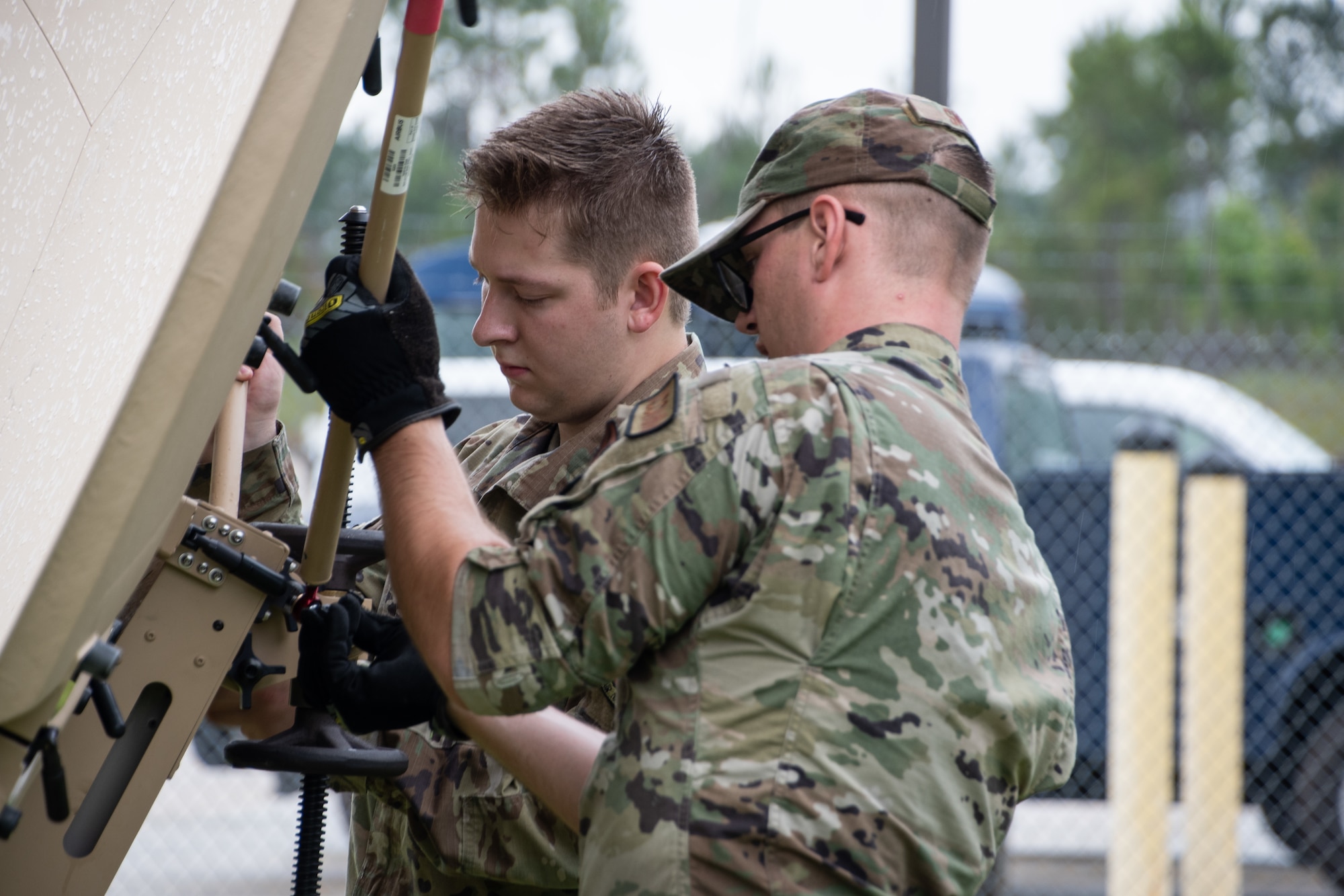 Members of the 239th Combat Communications Squadron ready a satellite communications antenna for use during Exercise BUMBU 22 at Camp Shelby, Miss., June 3, 2022. BUMBU 22 brings five combat communications squadrons with the 254th Combat Communications Group from their home stations located across the nation together for a consolidated training exercise. (U.S. Air National Guard photo by Airman 1st Class Kelly Ferguson)