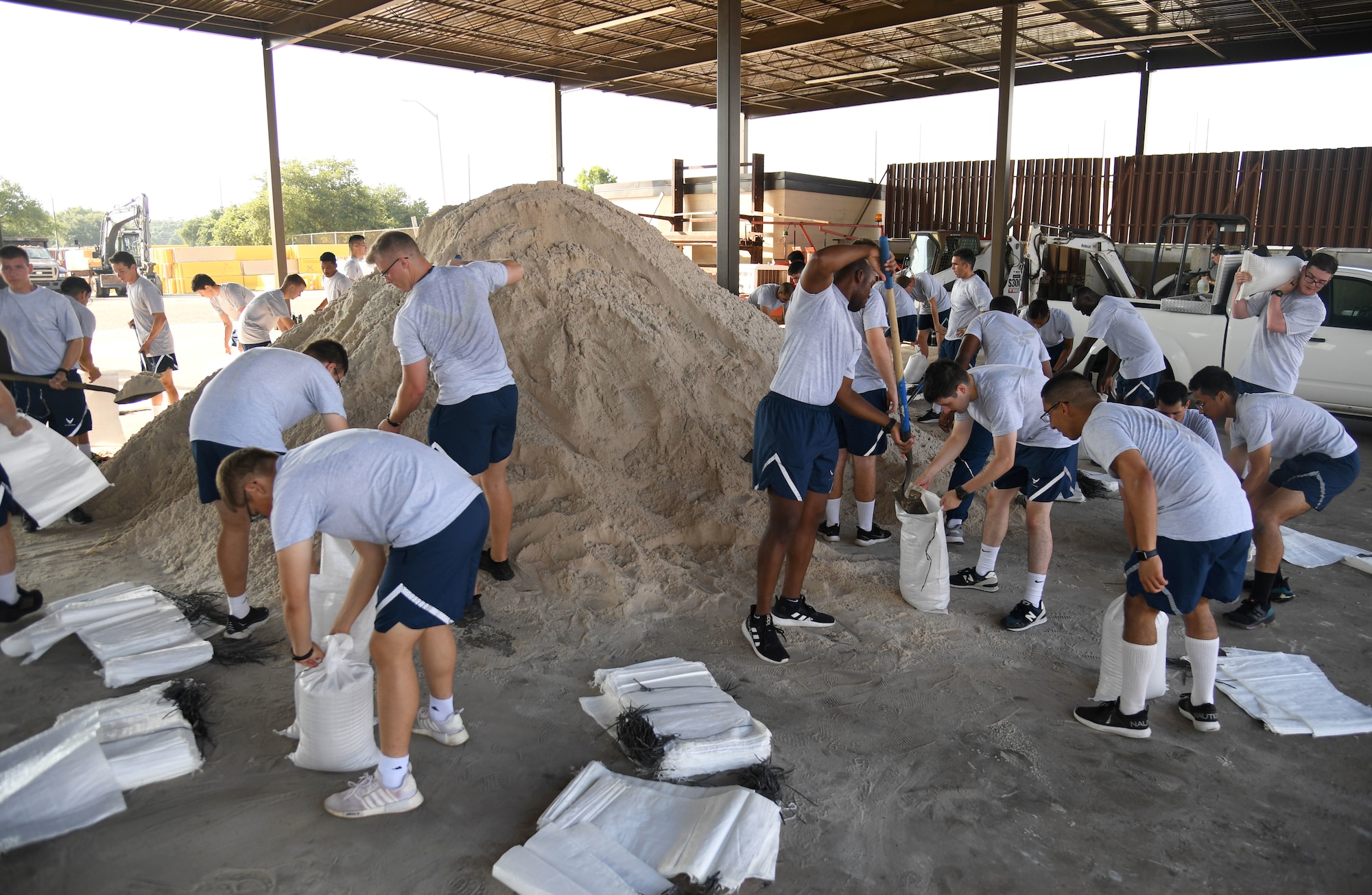 Airmen from the 338th Training Squadron fill sand bags in preparation for the 2022 hurricane season at Keesler Air Force Base, Mississippi, June 27, 2022. Over 40 Airmen assisted the 81st Civil Engineer Squadron with filling more than 2500 sand bags. Hurricane season runs from June 1 through November 30. (U.S. Air Force photo by Kemberly Groue)