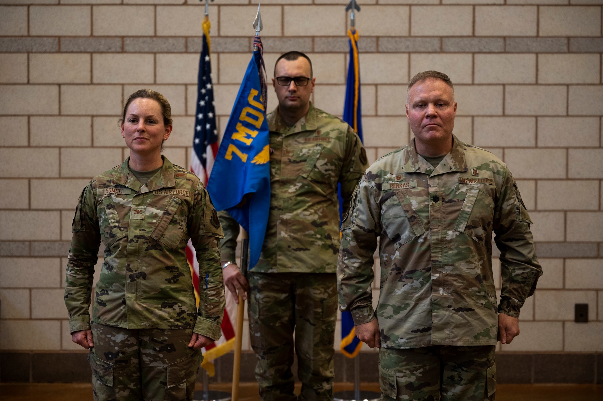 Col. Elizabeth Somsel, 7th Medical Group commander, Master Sgt. Dino Beharic, 7th Medical Support Squadron Tri-Care Operations Patient Administration flight chief, and Lt. Col. Michael Renkas, 7th MDSS commander, stand at the position of attention during the 7th MDSS Inactivation Ceremony at Dyess Air Force Base, Texas, June 24, 2022. The transfer into the 7th Healthcare Operations Squadron will eliminate no positions and only the squadron patch will change. (U.S. Air Force photo by Senior Airman Reilly McGuire)