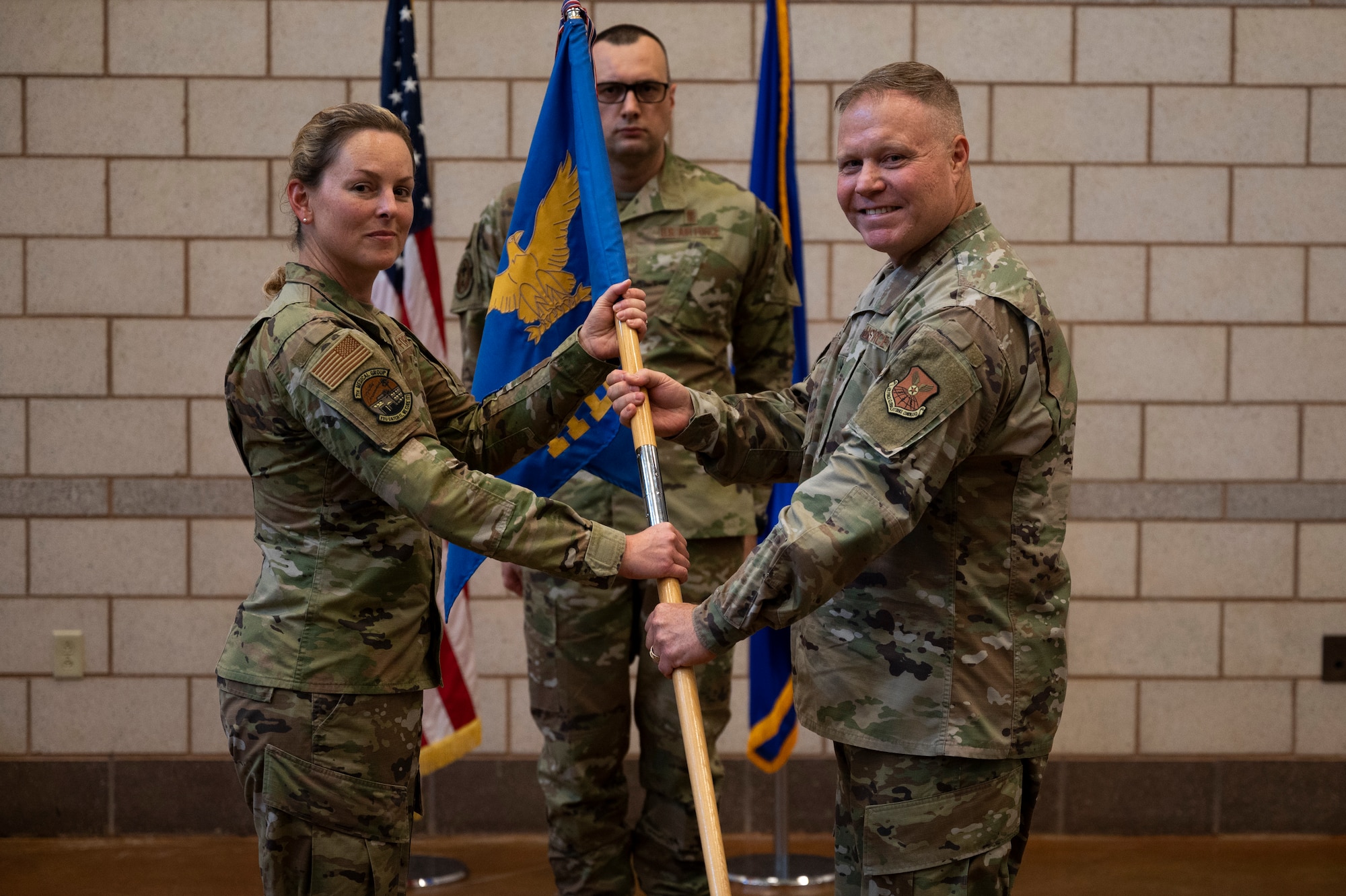 Col. Elizabeth Somsel, 7th Medical Group commander, takes the guidon from Lt. Col. Michael Renkas, outgoing 7th Medical Support Squadron commander, during the 7th MDSS Inactivation Ceremony at Dyess Air Force Base, Texas, June 24, 2022. Renkas took command of the 7th MDSS amid the COVID-19 pandemic in July of 2020. (U.S. Air Force photo by Senior Airman Reilly McGuire)