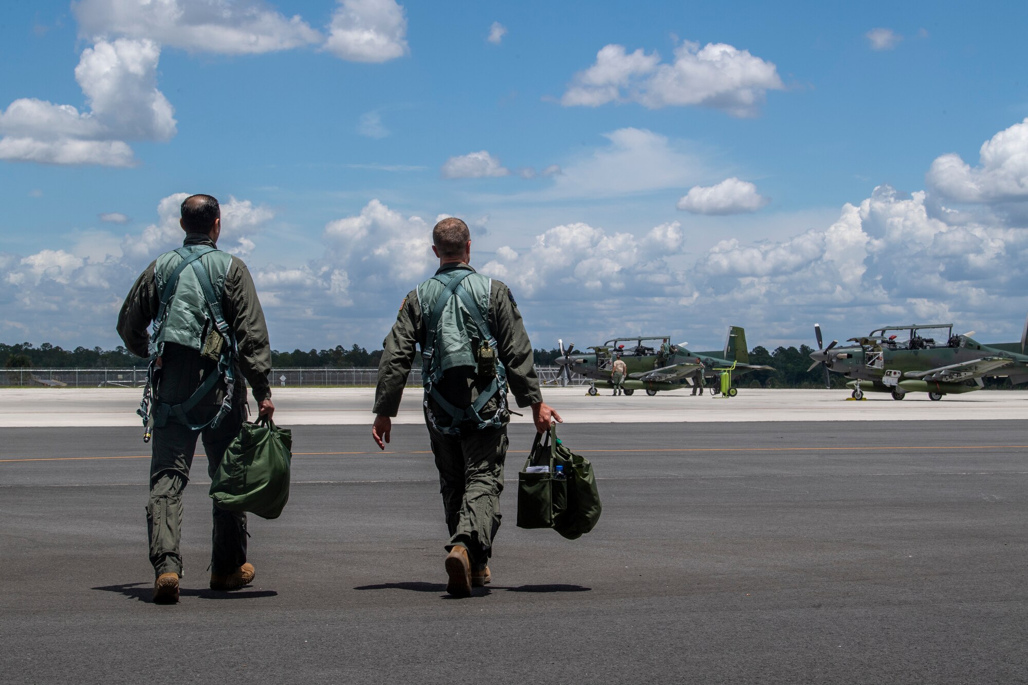 U.S. Air Force Lt. Col. Matthew Hall, AT-6E Wolverine instructor pilot, right, and Tunisian air force Capt. Jihed Makni, pilot, walk to an AT-6E at Avon Park Air Force Range, Florida, May 12, 2022. The U.S. Air Force partnered with Colombia, Tunisia, Nigeria, and Thailand to co-develop tactics, techniques and procedures to combat violent extremist organizations while demonstrating the capabilities of the Airborne Extensible Relay Over-Horizon Network. (U.S. Air Force photo by Airman 1st Class Deanna Muir)
