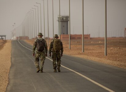 U.S. Army Soldiers assigned to the 19th Special Forces Group (Airborne), Utah Army National Guard, walk towards the airfield in Grier Labouihi, Morocco, to conduct a combined airborne operation with Royal Moroccan Army soldiers and Tunisian Land Army paratroopers during African Lion 22, June 19, 2022.